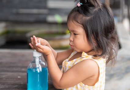 Child Hands Using Wash Hand Sanitizer Gel Pump Dispenser, Selected Focus